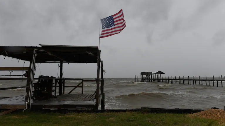 una-bandera-estadounidense-ondea-al-viento-provocado-por-los-efectos-del-huracan-isaias-en-una-playa-vacia-en-mon-louis-island-alabama-foto-apoctavio-jones-BVYBGAJISVBJ7E6YODGOIHM7RI